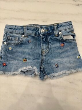 Cat and Jack size 4/5 frayed shorts with floral design.  Like new